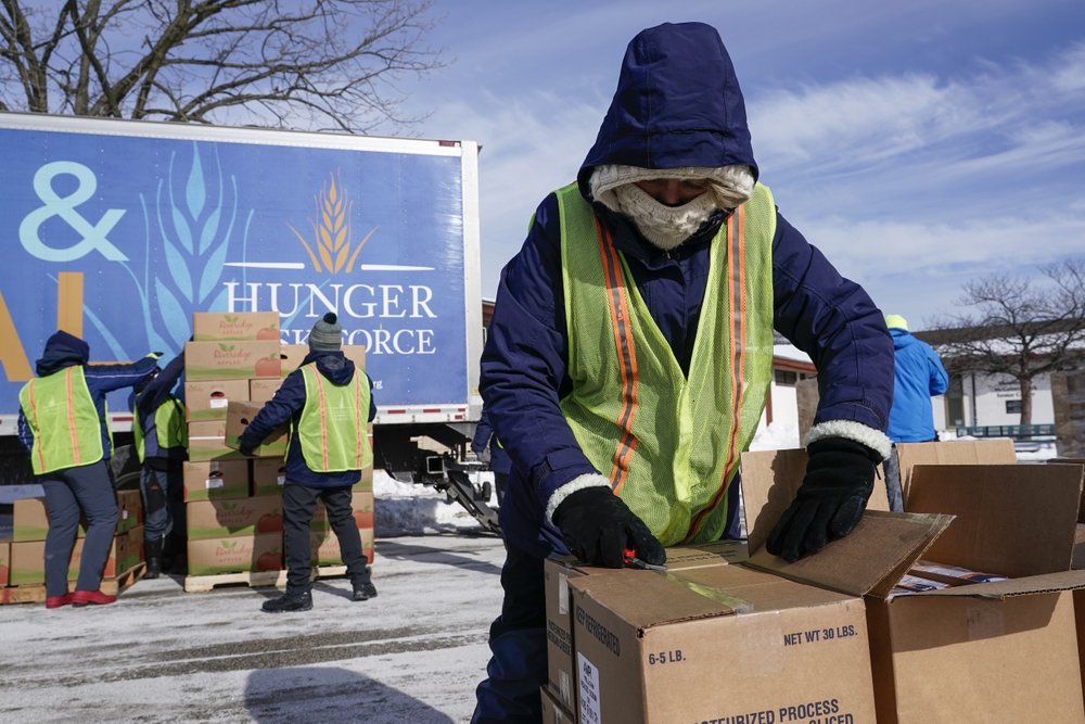 Hunger Task Force Workers distribute food